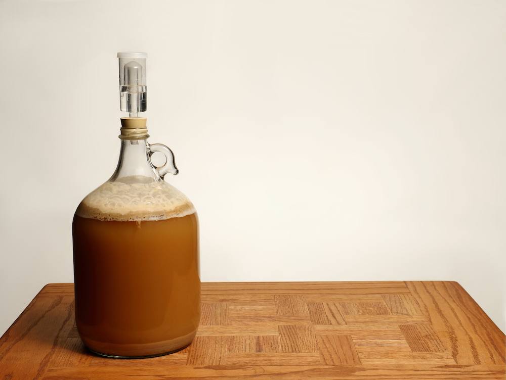 1 gallon glass fermenter on wooden table